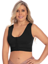 Woman wearing a black sports bra on a white background
